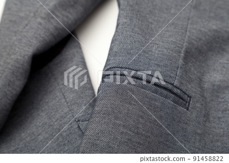 details and quality shot of formal black or dark grey wool suit fabric texture. with button decoration under light and shadow ambient. details and quality shot of formal black or dark grey wool suit fabric texture. with button decoration under light and shadow ambient. 91458822