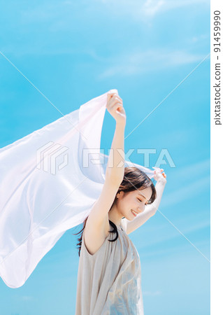 Woman portrait on blue sky background Woman portrait on blue sky background 91459990
