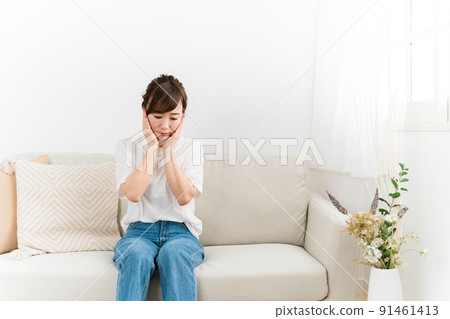 Japanese woman worried about her sofa at home (shock) Japanese woman worried about her sofa at home (shock) 91461413