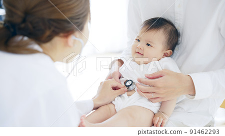 Doctor who examines a baby Pediatrician Infant examination 91462293