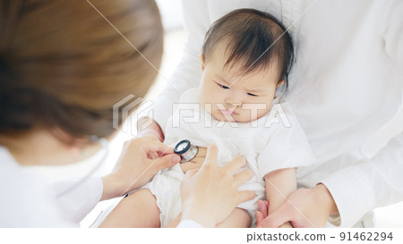 Doctor who examines a baby Pediatrician Infant examination 91462294
