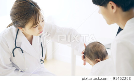 Doctor who examines a baby Pediatrician Infant examination 91462298