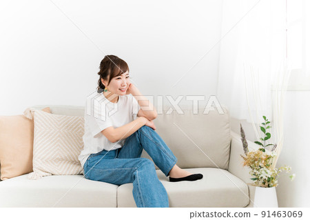 Japanese woman in denim relaxing on the sofa at home 91463069