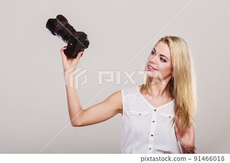 Beautiful woman with camera. 91466018