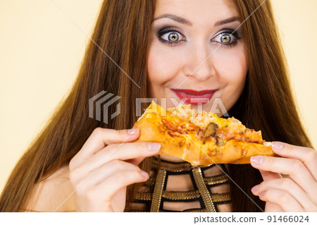 Woman eating hot pizza slice Woman eating hot pizza slice 91466024