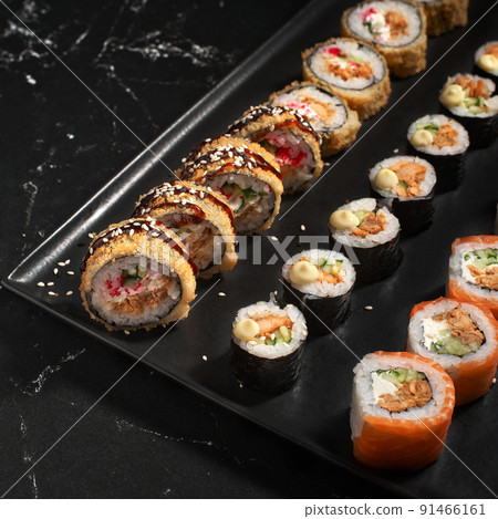Sushi set. Roll with fresh ingredients on stone background. Top view. Sushi set. Roll with fresh ingredients on stone background. Top view. 91466161