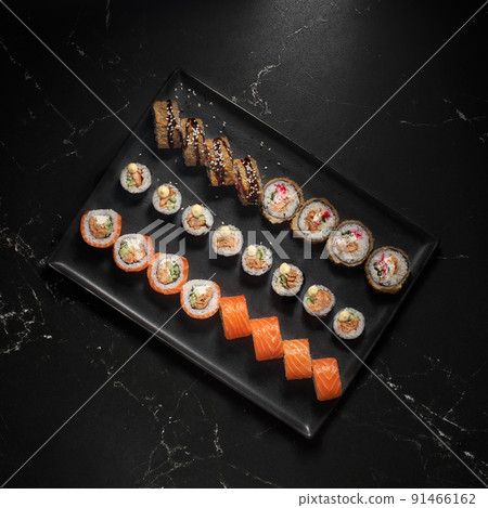 Sushi set. Roll with fresh ingredients on stone background. Top view. 91466162