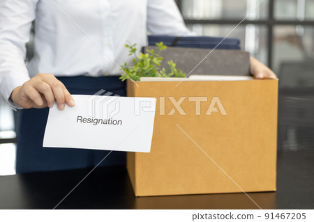 Female employee submits her resignation letter and packs her work equipment in a box to prepare to move to work, Can't bear the burden or pressure, Employment contract is expired. Female employee submits her resignation letter and packs her work equipment in a box to prepare to move to work, Can't bear the burden or pressure, Employment contract is expired. 91467205