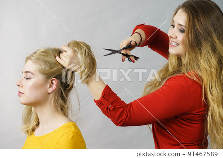 Woman with scissors ready to hair cutting Woman with scissors ready to hair cutting 91467589