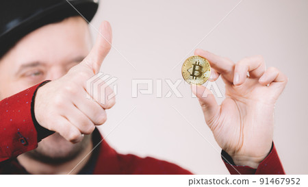 Man holding golden bitcoin Man holding golden bitcoin 91467952