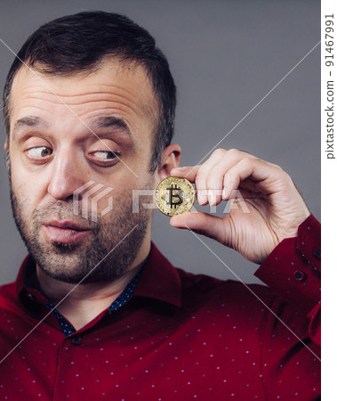Man holding golden bitcoin Man holding golden bitcoin 91467991