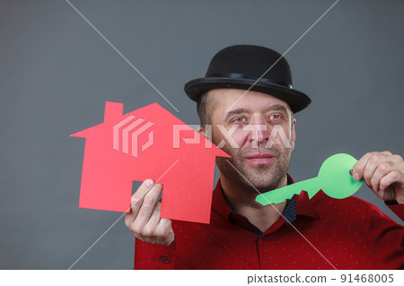 Man holding red house model Man holding red house model 91468005