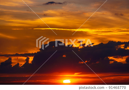 beautiful dramatic sunset sky, bright sunlight and dark silhouette of clouds as a background beautiful dramatic sunset sky, bright sunlight and dark silhouette of clouds as a background 91468770