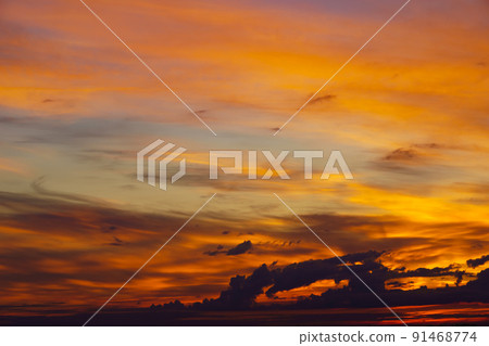 beautiful dramatic sunset sky, bright sunlight and dark silhouette of clouds as a background 91468774