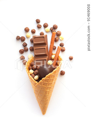 Ice cream waffle cone with chocolate candy isolated on white background Ice cream waffle cone with chocolate candy isolated on white background 91469008