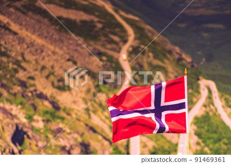 Norwegian flag and Trollstigen mountain road Norwegian flag and Trollstigen mountain road 91469361