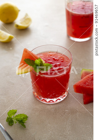 Watermelon drink, juice, lemonade with lemon and fresh mint leaves. Refreshing summer drink. DEtox healthy beverage, watermelon smoothie. Watermelon drink, juice, lemonade with lemon and fresh mint leaves. Refreshing summer drink. DEtox healthy beverage, watermelon smoothie. 91469657