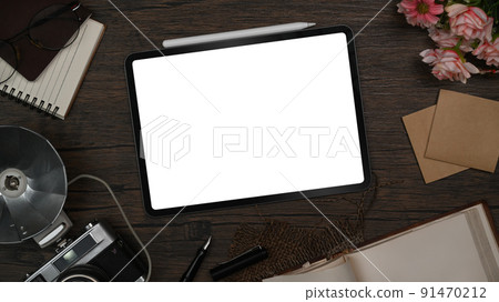 Stylish workspace with digital tablet, retro camera, notebook and sticky notes on wooden table 91470212