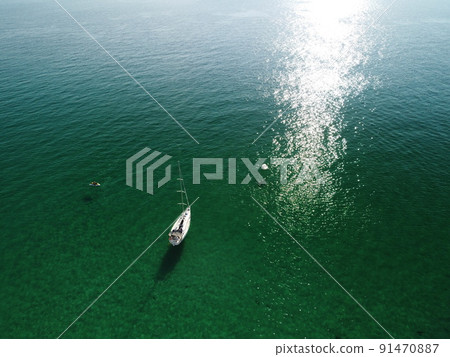 Aerial panoramic view of seascape with crystal clear azure sea and rocky shores. Yachts in a beautiful lagoon on backdrop of rocks. The concept of an ideal destination for summer travel and vacation. 91470887