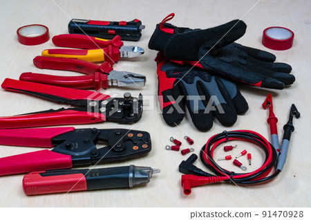Red professional electrician tools on wood background. 91470928