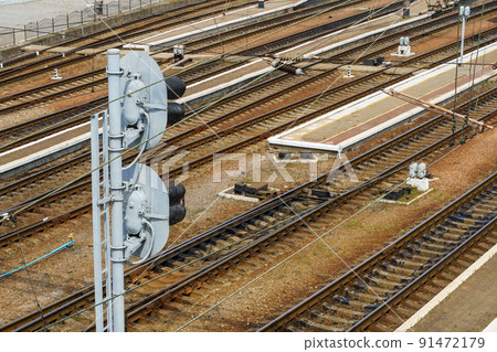railway station infrastructure - rails, traffic light and platform without people 91472179