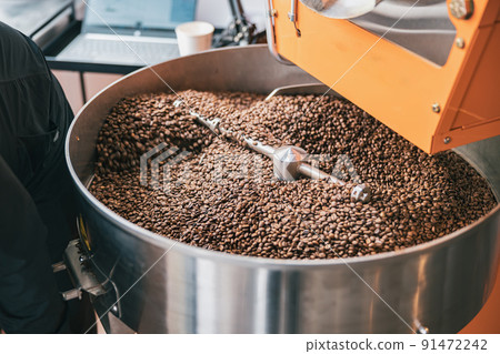 Close up of coffee roasting machine with coffee beans in small coffee manufacturing 91472242