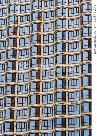 construction of a modern high-rise building, exterior of a apartment house under construction with new windows construction of a modern high-rise building, exterior of a apartment house under construction with new windows 91472275