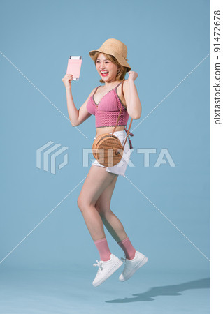 Young traveling girl isolated on blue color background Young traveling girl isolated on blue color background 91472678