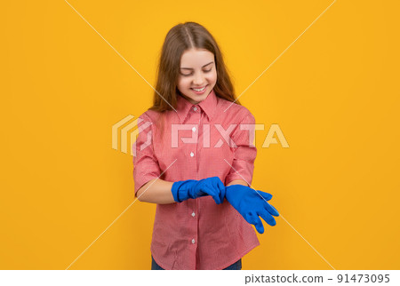 happy child wearing rubber gloves on yellow background happy child wearing rubber gloves on yellow background 91473095