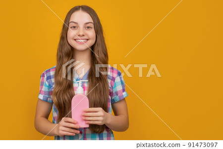 cheerful kid with liquid soap bottle on yellow background cheerful kid with liquid soap bottle on yellow background 91473097