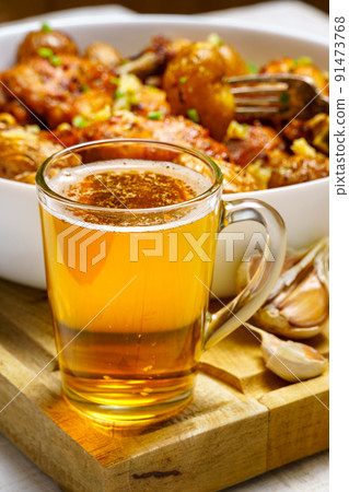 tasty lunch in rural style, healthy food - glass of beer, fried chicken meat and unpeeled roasted potatoes, chopped leeks, cooked food on a white wooden boards tasty lunch in rural style, healthy food - glass of beer, fried chicken meat and unpeeled roasted potatoes, chopped leeks, cooked food on a white wooden boards 91473768