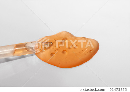 Pipette with orange gel, transparent fluid hyaluronic acid. Cosmetics, science and healthcare concept closeup. Dose of retinol. Front view, high angle shot. Beauty product closeup, banner Pipette with orange gel, transparent fluid hyaluronic acid. Cosmetics, science and healthcare concept closeup. Dose of retinol. Front view, high angle shot. Beauty product closeup, banner 91473853