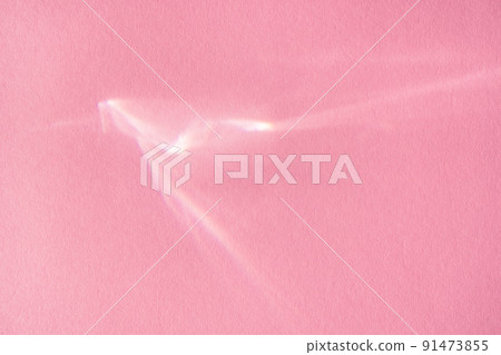 Beautiful lights and shadows of glass on pink background. Overlay mode. Caustic effect of light. Sun hard reflection. Shadows texture. Blurred water backdrop. Top view. Trendy concept Beautiful lights and shadows of glass on pink background. Overlay mode. Caustic effect of light. Sun hard reflection. Shadows texture. Blurred water backdrop. Top view. Trendy concept 91473855