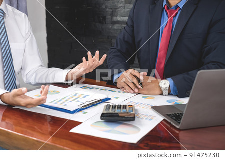 Two business leaders talk about charts, financial graphs showing results are analyzing and calculating planning strategies, business success building processes Two business leaders talk about charts, financial graphs showing results are analyzing and calculating planning strategies, business success building processes 91475230