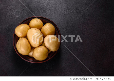 A pile of young potatoes on the table. The benefits of vegetables 91476430