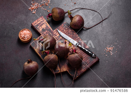 A pile of raw beets on the table. The benefits of vegetables A pile of raw beets on the table. The benefits of vegetables 91476586