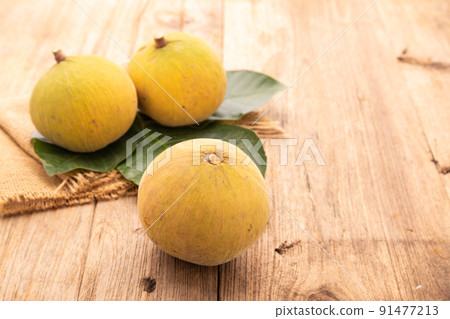 Santol fruit on wooden table background. Food and healthcare concept 91477213