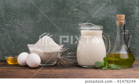 Fresh ingredients for dough, flour, milk, eggs, vegetable oil Fresh ingredients for dough, flour, milk, eggs, vegetable oil 91478249