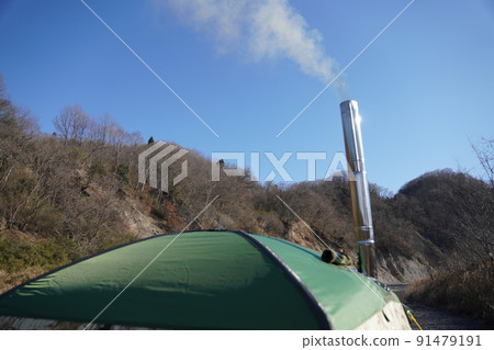 A stove with smoke coming out of a wood stove A stove with smoke coming out of a wood stove 91479191
