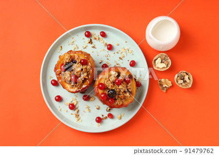Concept of tasty food with baked apples on orange background 91479762