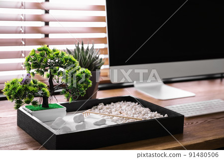 Modern workplace with beautiful miniature zen garden and computer in room 91480506