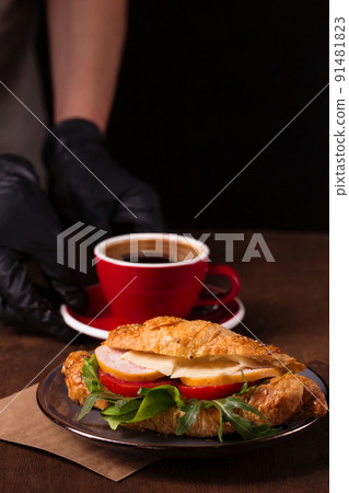 Croissant with turkey, vegetables and aromatic coffee 91481823