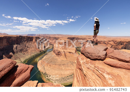 Adventurous Caucasian Woman at Horseshoe Bend in Page, Arizona, United States. Adventurous Caucasian Woman at Horseshoe Bend in Page, Arizona, United States. 91482743