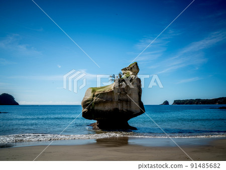 A lonely rock is standing in the ocean in New Zealand. A lonely rock is standing in the ocean in New Zealand. 91485682