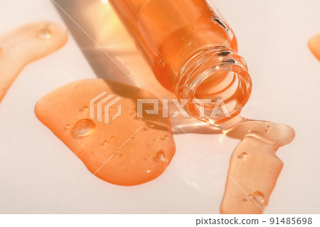 Fluid hyaluronic acid, serum, cosmetic gel flowing out of the bottle on white background. Beauty, science and healthcare concept. Dose of retinol in macro. Beauty product presentation Fluid hyaluronic acid, serum, cosmetic gel flowing out of the bottle on white background. Beauty, science and healthcare concept. Dose of retinol in macro. Beauty product presentation 91485698