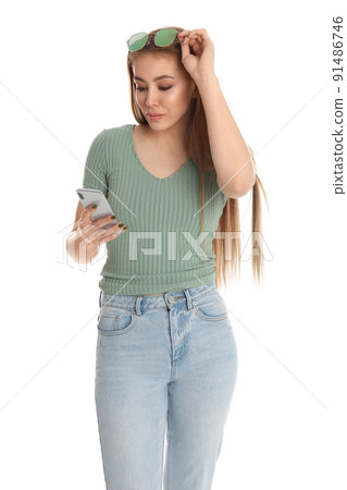 Teenage girl using smartphone on white background Teenage girl using smartphone on white background 91486746
