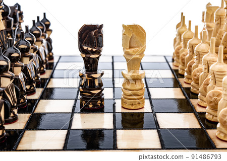 Beige Brown Wooden chess different pieces figures standing on chessboard. Closeup game concept competition, Classic Tournament. Beige Brown Wooden chess different pieces figures standing on chessboard. Closeup game concept competition, Classic Tournament. 91486793