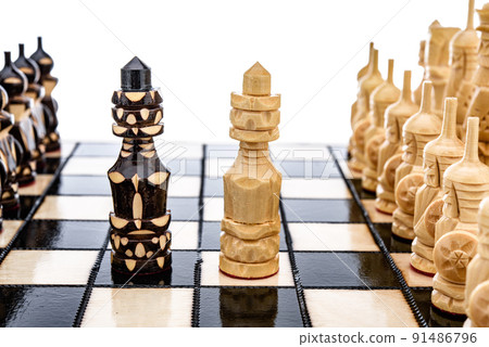 Beige Brown Wooden chess different pieces figures standing on chessboard. Closeup game concept competition, Classic Tournament. Beige Brown Wooden chess different pieces figures standing on chessboard. Closeup game concept competition, Classic Tournament. 91486796