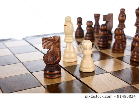 Beige Brown Wooden chess different pieces figures standing on chessboard. Closeup game concept competition, Classic Tournament. Beige Brown Wooden chess different pieces figures standing on chessboard. Closeup game concept competition, Classic Tournament. 91486824