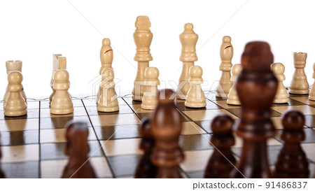Beige Brown Wooden chess different pieces figures standing on chessboard. Closeup game concept competition, Classic Tournament. Beige Brown Wooden chess different pieces figures standing on chessboard. Closeup game concept competition, Classic Tournament. 91486837